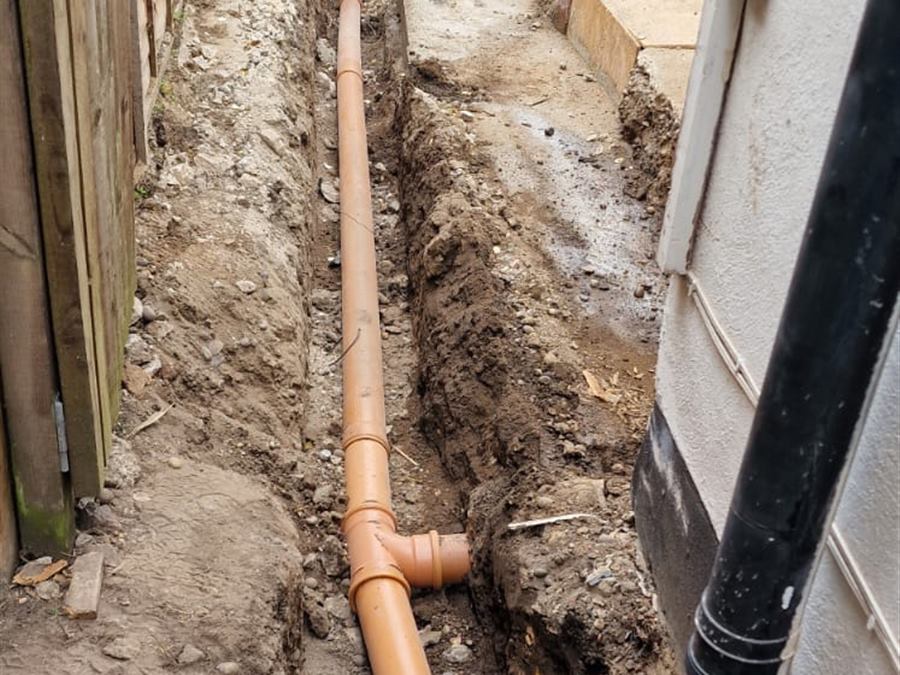 New underground drainage pipework laid in a trench