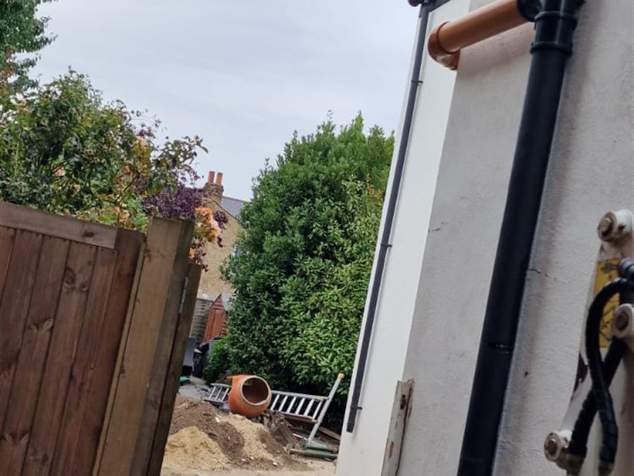 External drainage and services installed along the side of a house