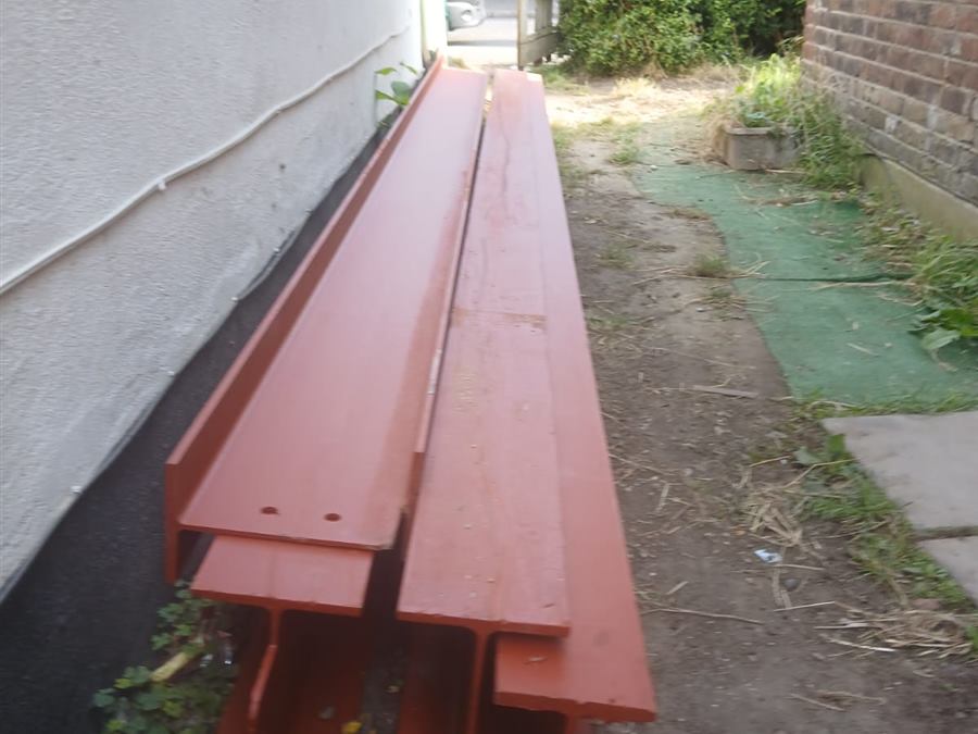 Red RSJ steel beams delivered to site ready for installation