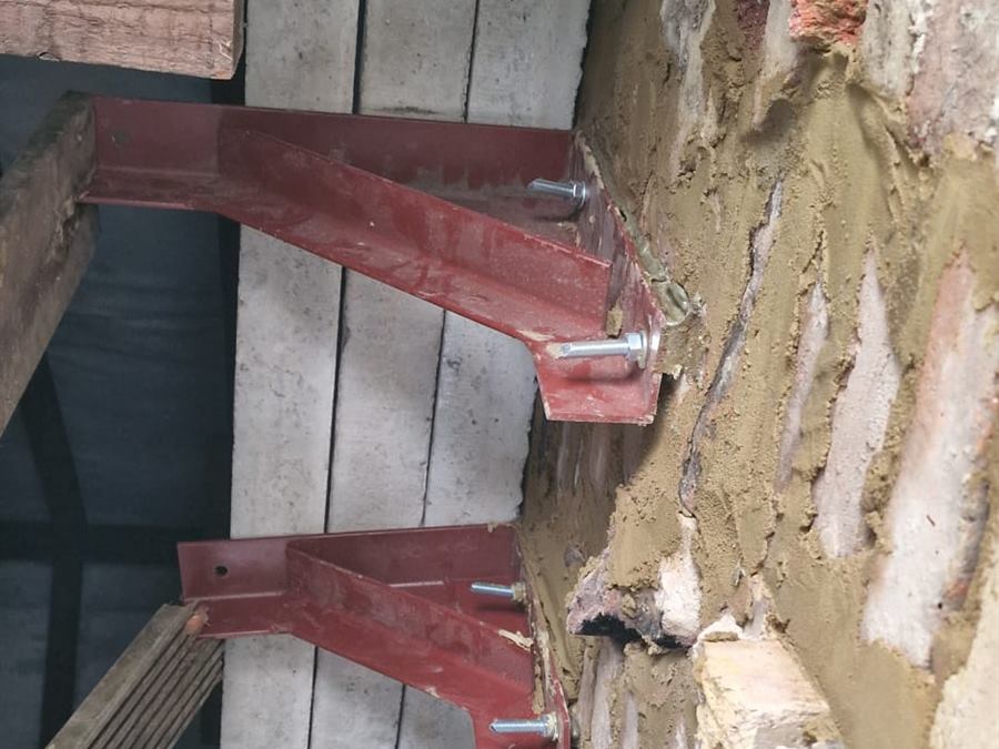 Needle beams supporting brickwork during a structural opening